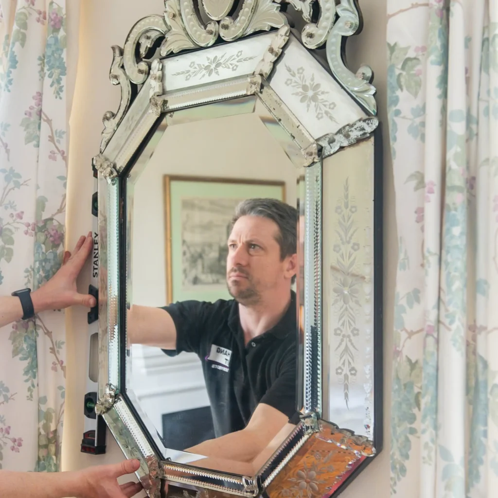 Technician showing how to hang a heavy mirror