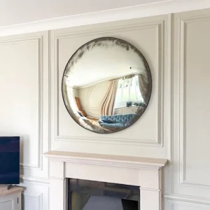 Picture Hanging Maidenhead. Convex mirror hung above a fireplace.